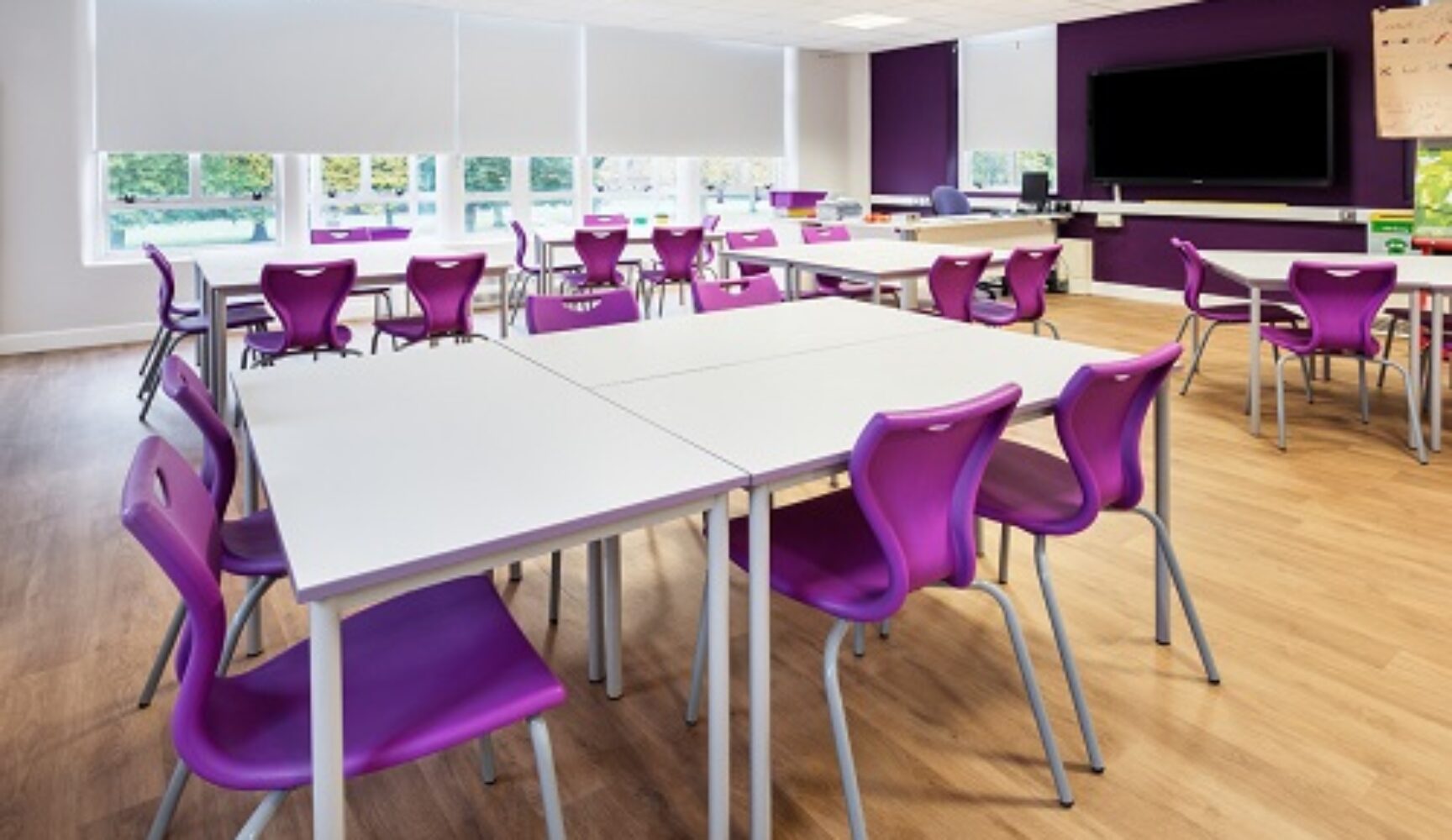 Clean new classroom with purple furniture accents